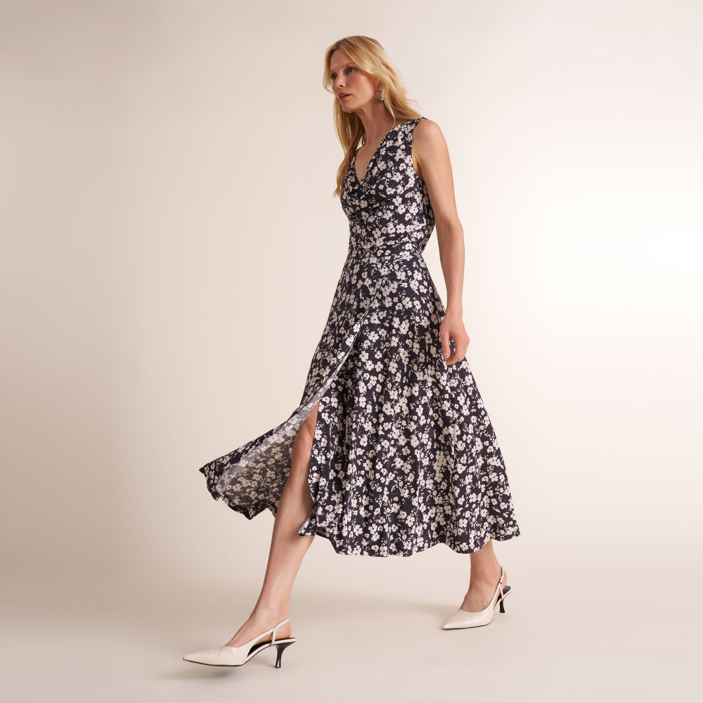 Woman wearing a matching set of a v neck tank top and long skirt in a black and white print