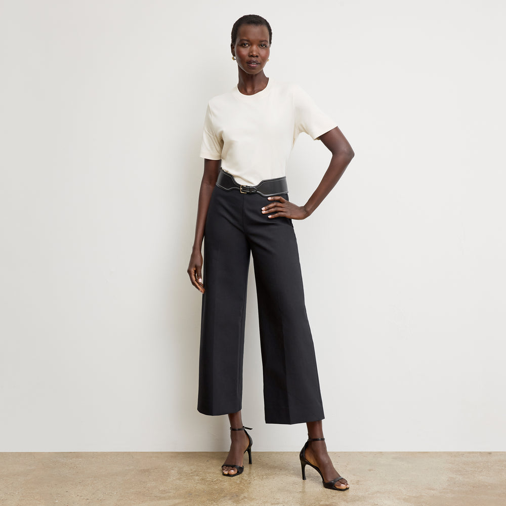 Front image of a woman wearing the adler pant in black