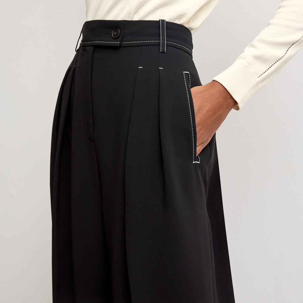 detail image of a woman wearing the bia pants in black with topstitch