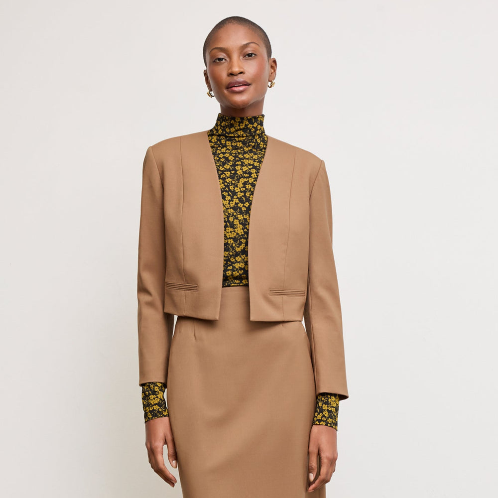 Front image of a woman standing wearing the Neale jacket in camel