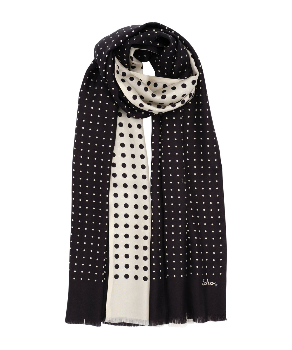 Black and white polka dot scarf with 'whoo' branding on a white background