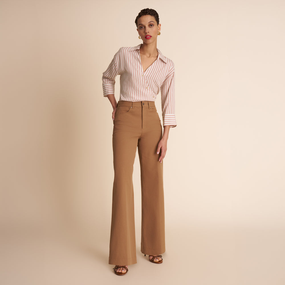 woman in stripped shirt and beige pants.