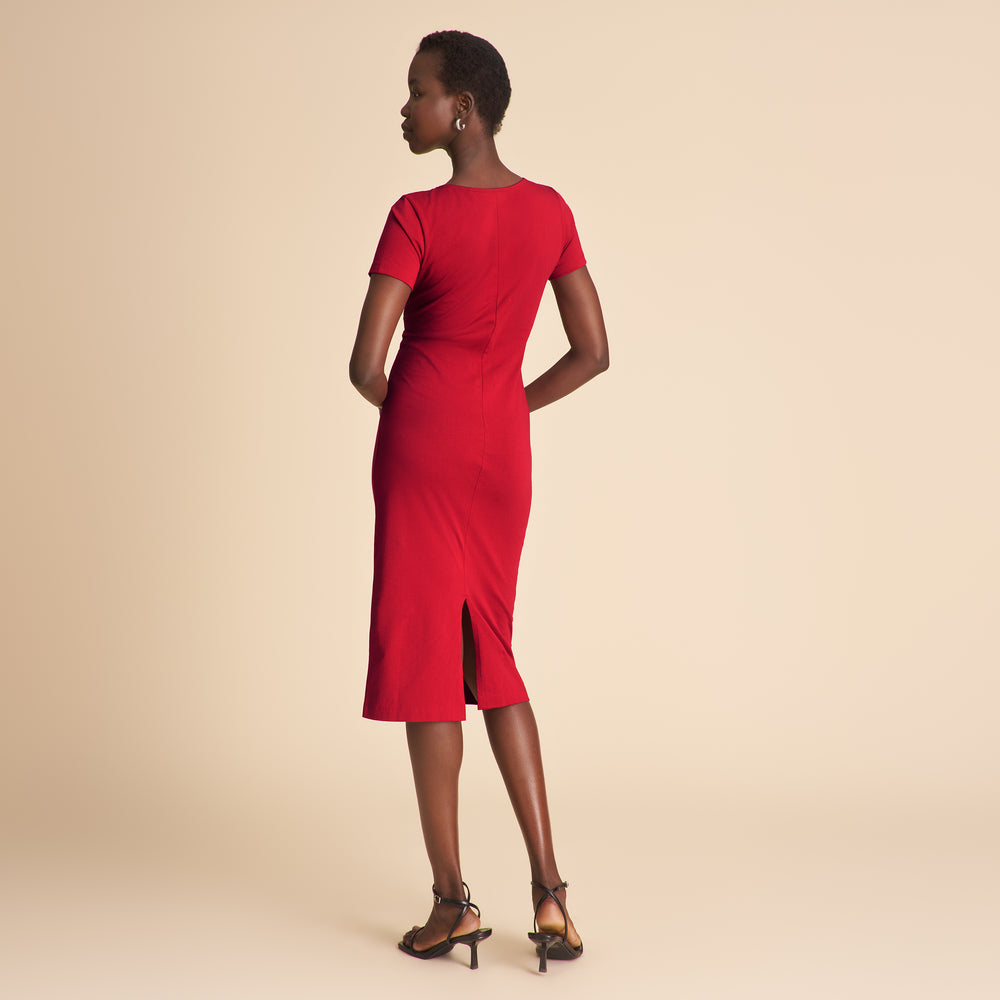 Woman wearing a red dress on a beige background