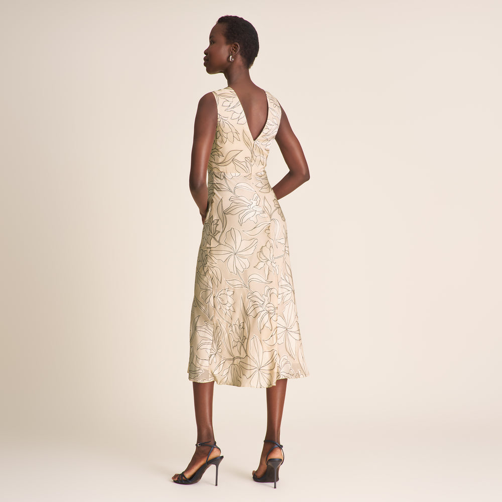 Woman wearing a floral dress on a plain background