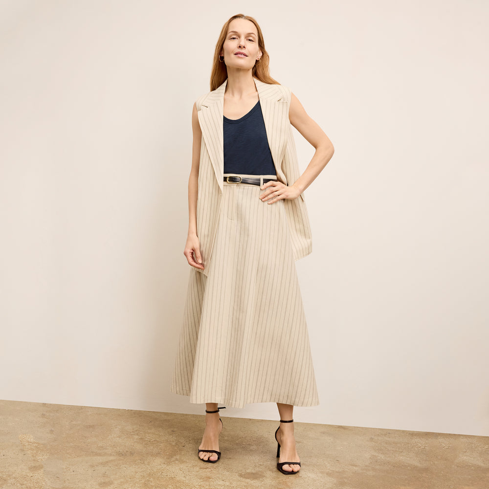 front image of a woman wearing the olia skirt in linen stripe