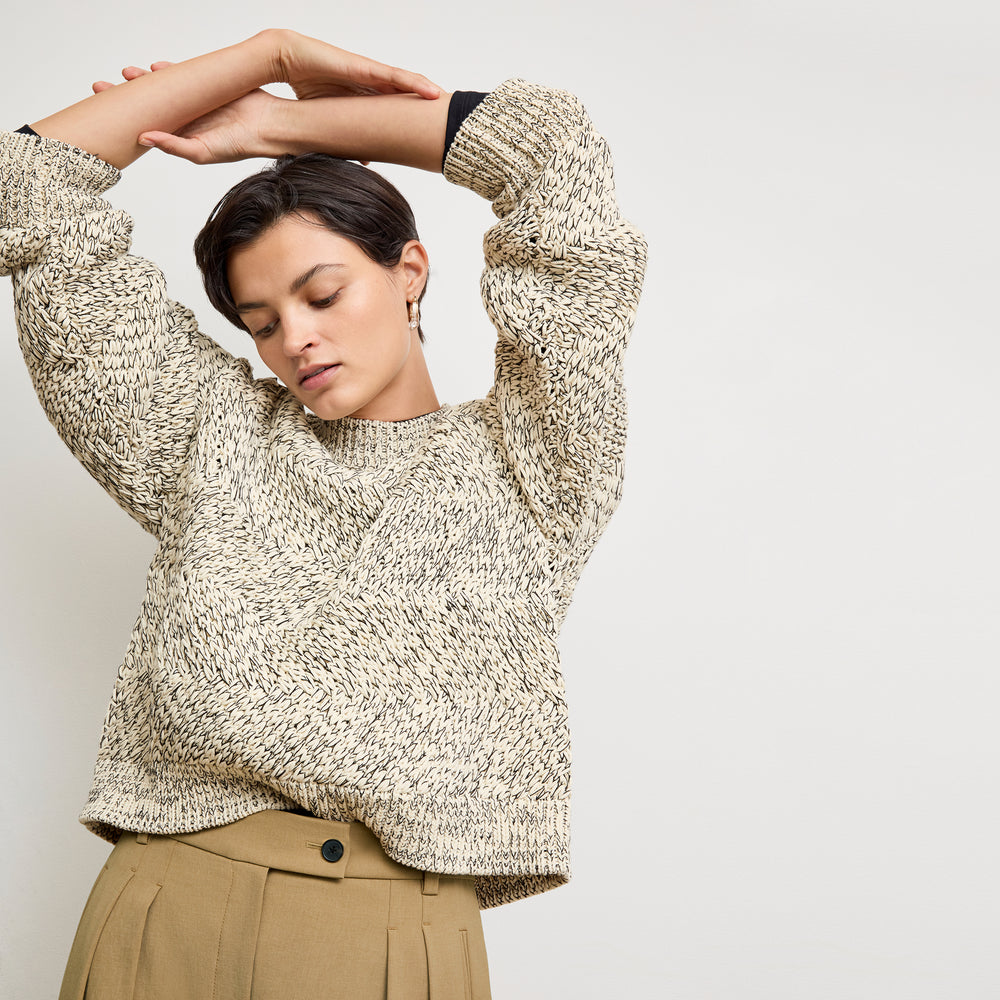 front image of a woman wearing the kiki sweater in ivory/black