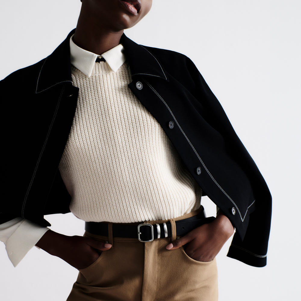 front image of a woman wearing the nicky jacket in black
