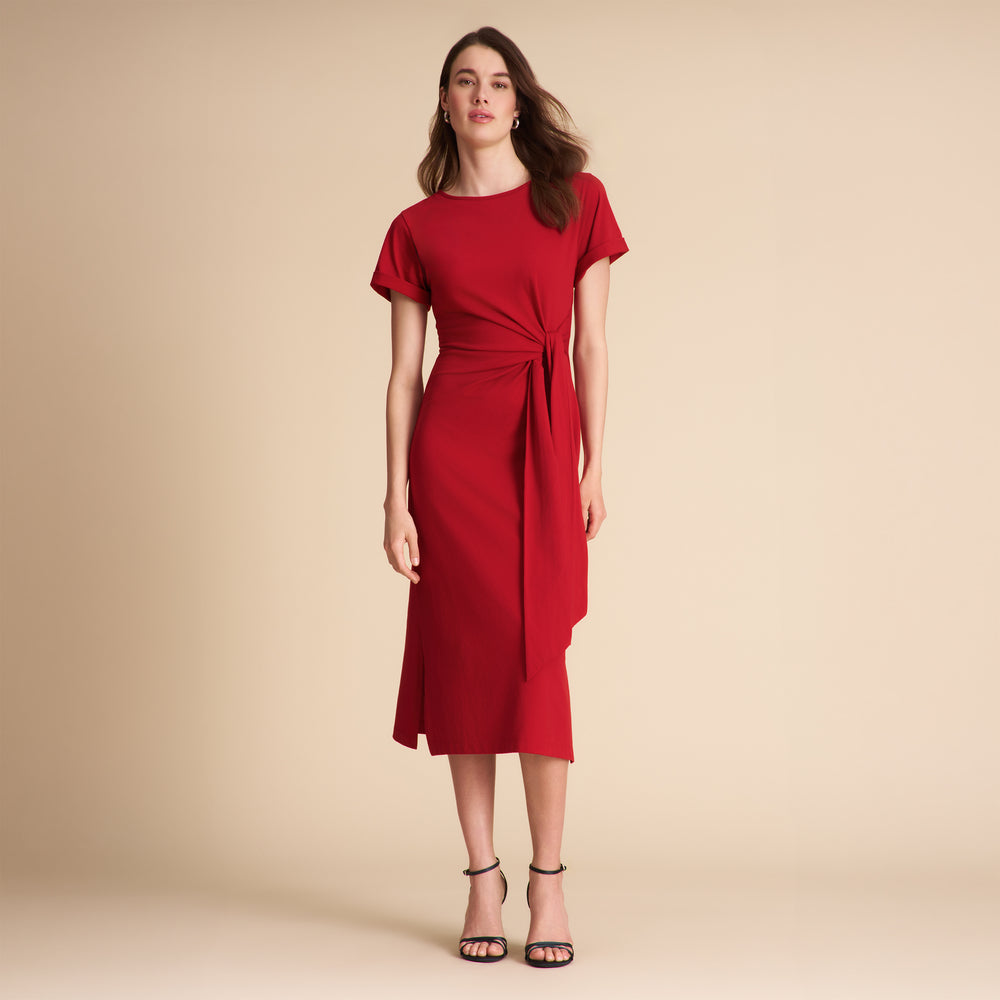 Woman wearing a red dress on a beige background