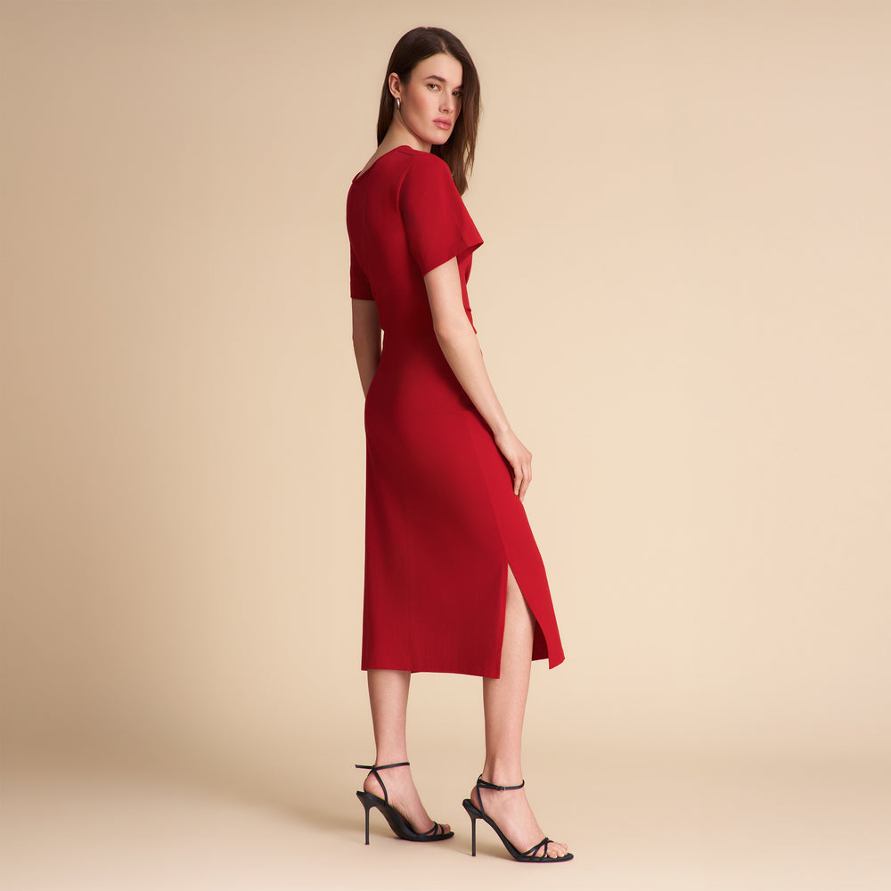 Woman wearing a red dress on a beige background
