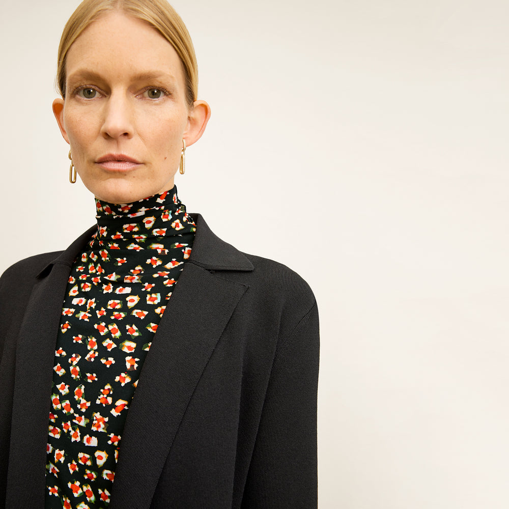 front image of a woman wearing the axam top in kaleidoscope print