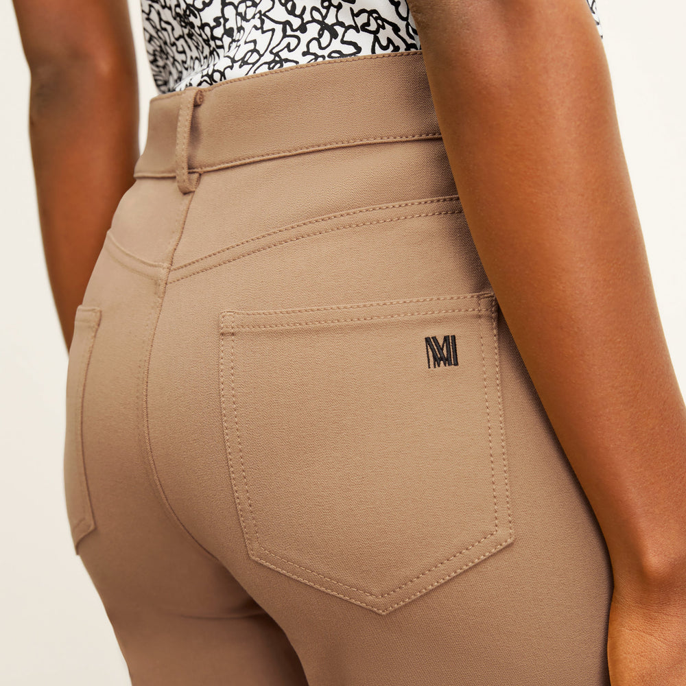 back image of a woman wearing the roma jean in saddle
