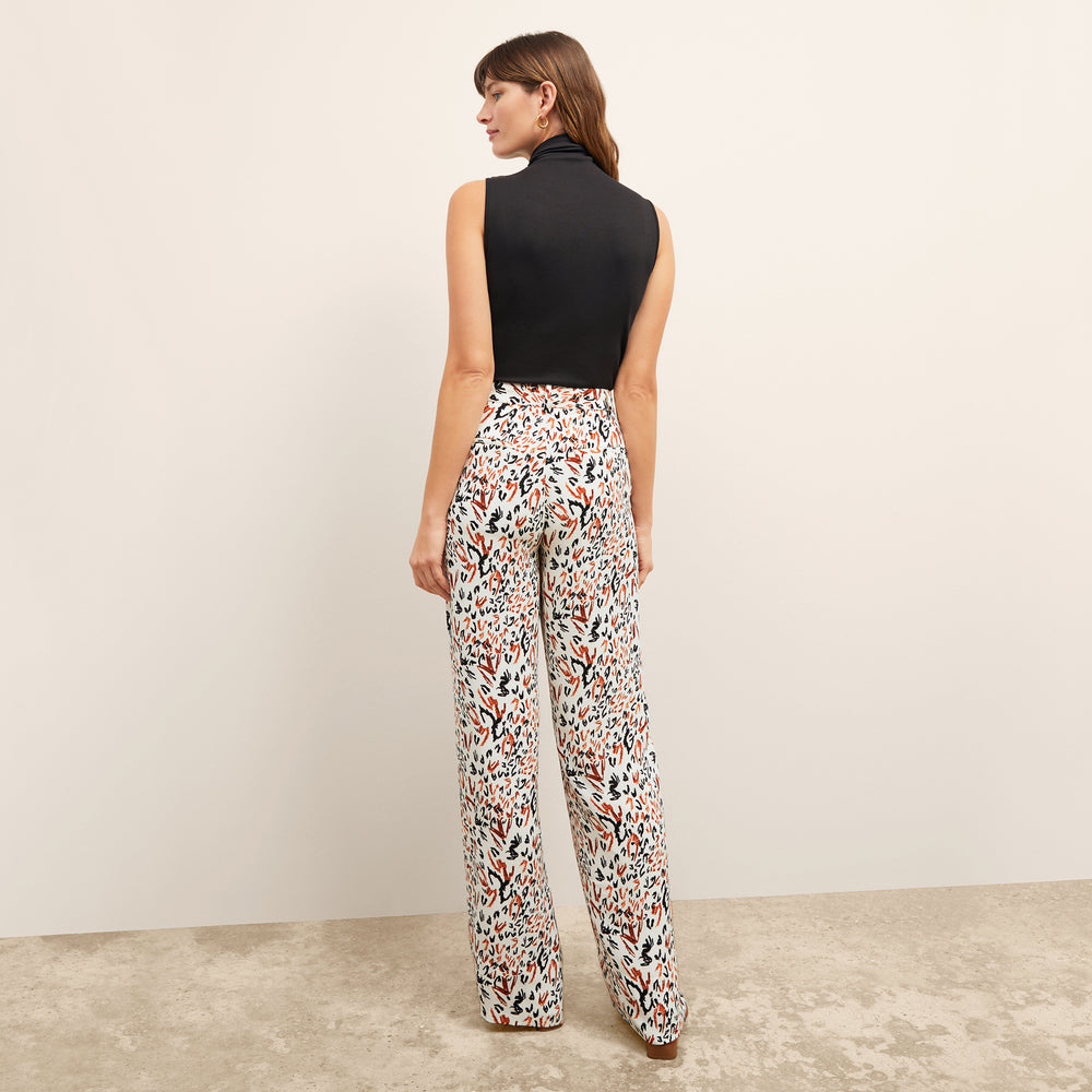 back image of a woman wearing the tinsley trousers in leopard sketch