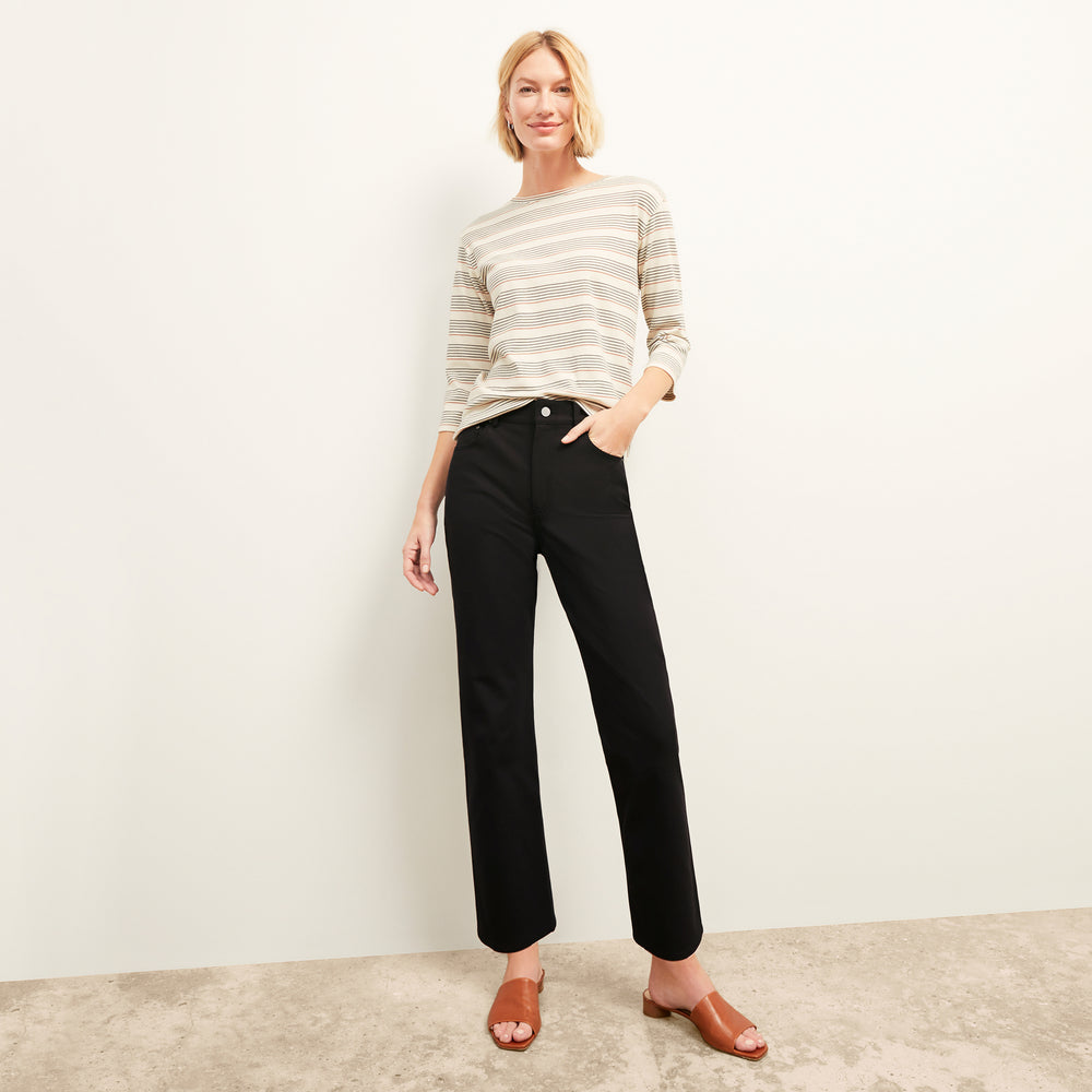 front image of a woman wearing the owen t-shirt in signature stripe