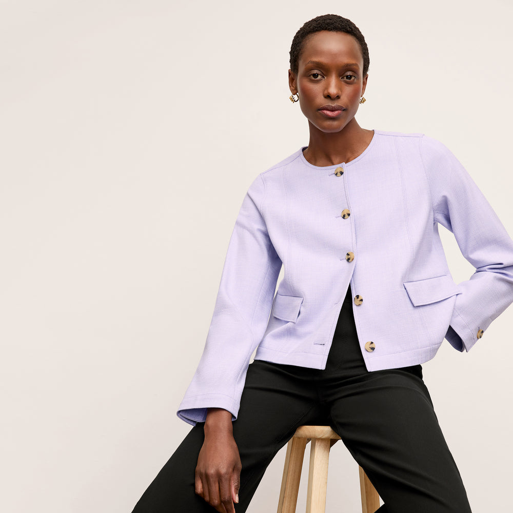 front image of a woman wearing the aniya jacket in lilac/ivory