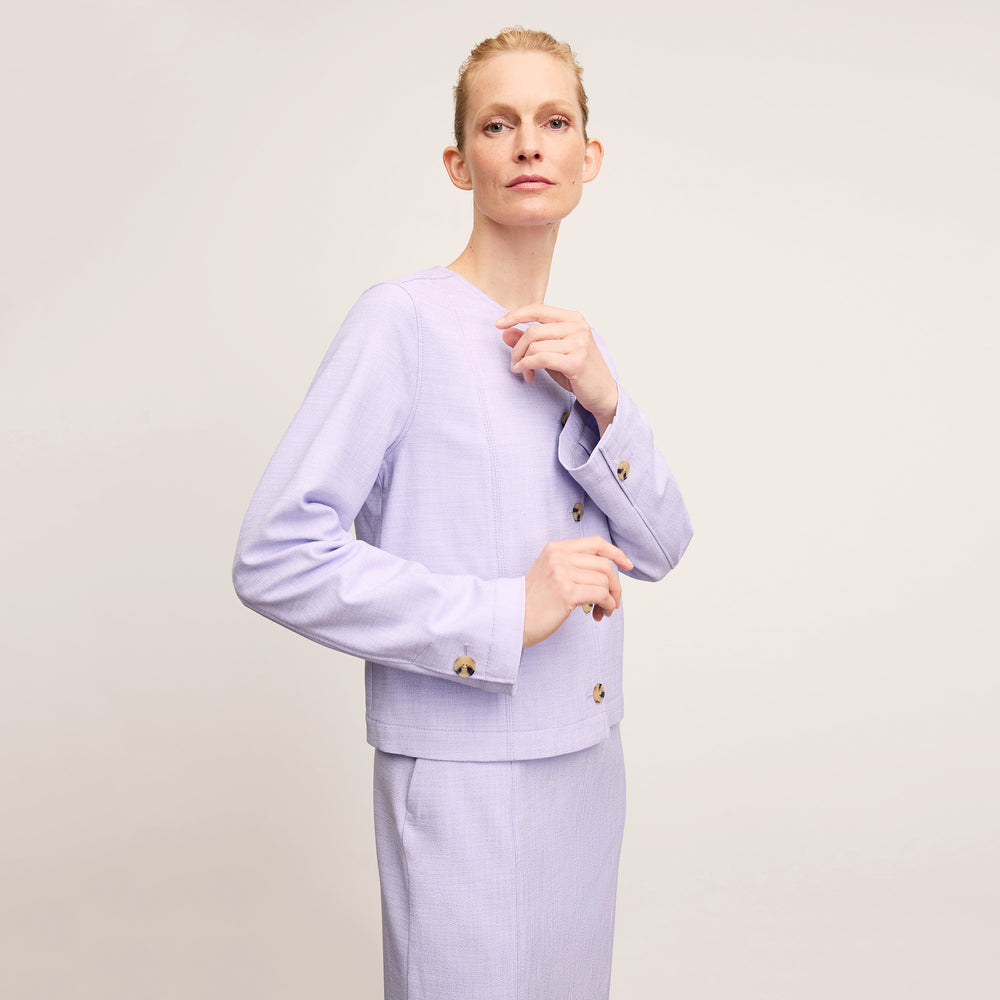 front image of a woman wearing the constance dress in lilac/ivory