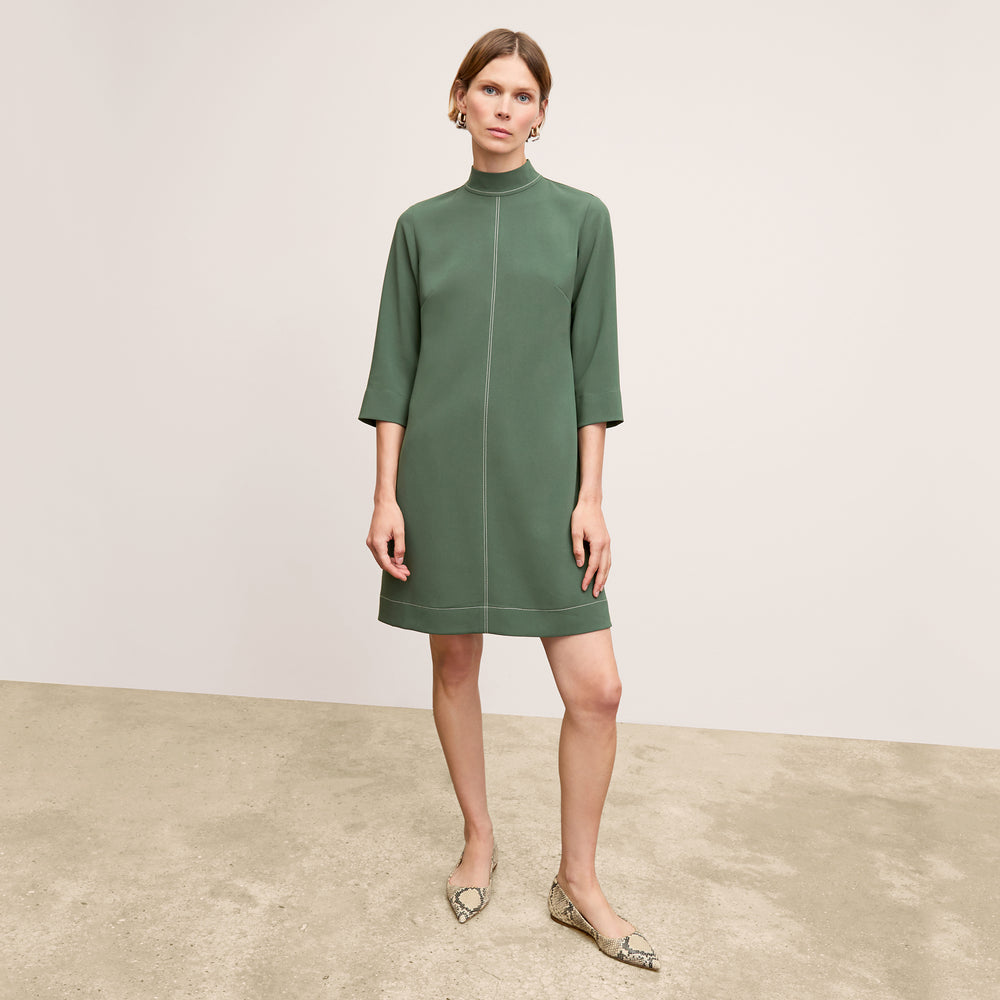 front image of a woman wearing the kinsley dress in dusty pine