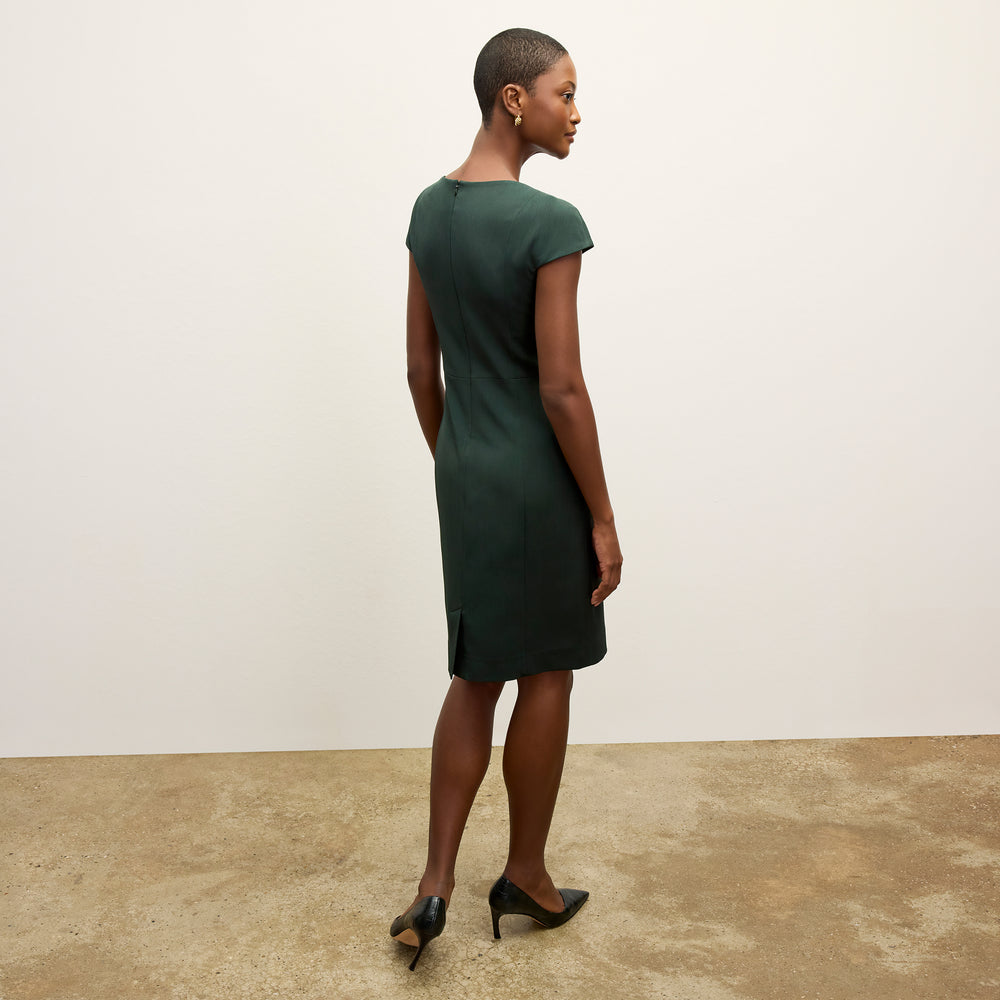 back image of a woman wearing the ashley dress in emerald