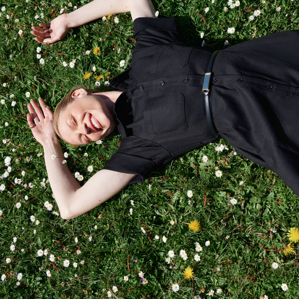 woman in grass with a black dress.