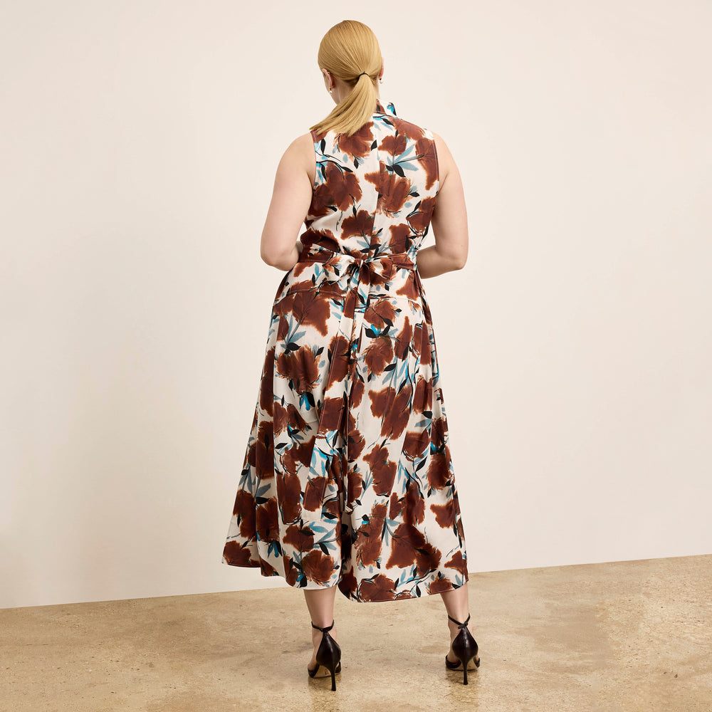 Woman wearing a floral dress with a plain background