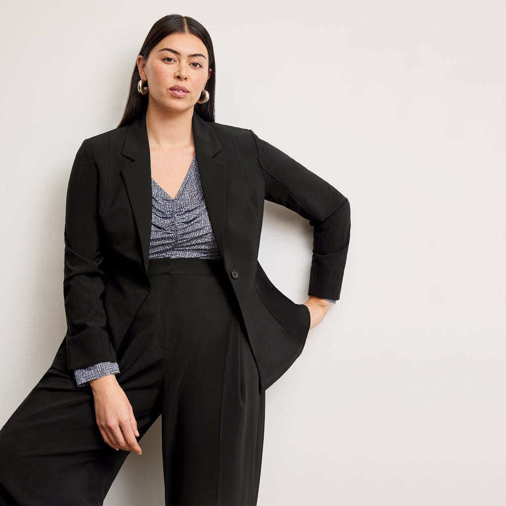 Front image of a woman wearing the amina top in blueprint sketch