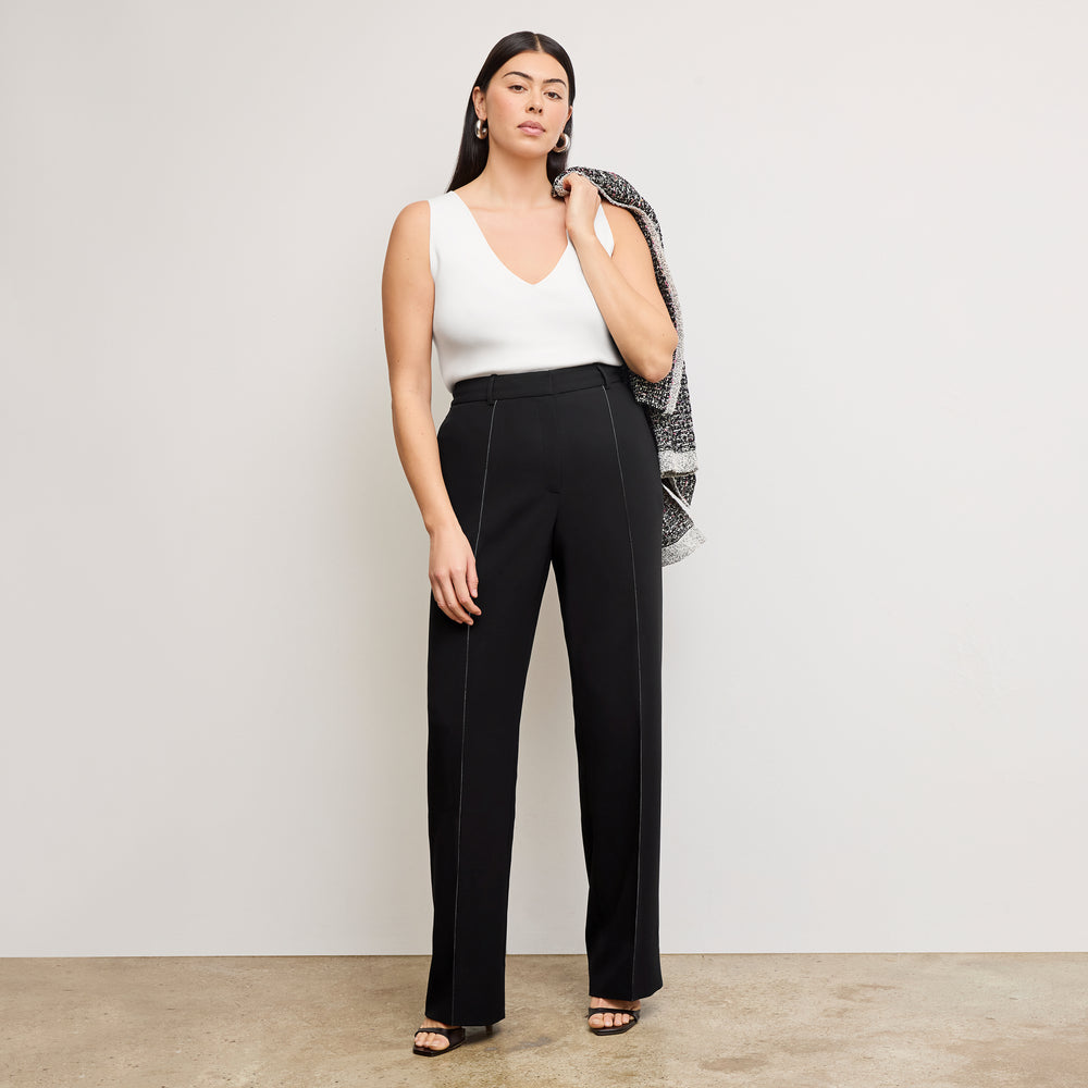 front image of a woman wearing the alecia top in ivory