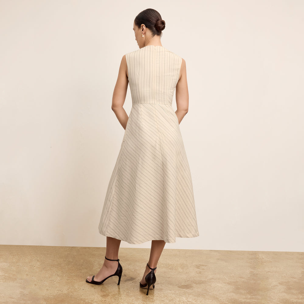 back image of a woman wearing the tati dress in linen stripe
