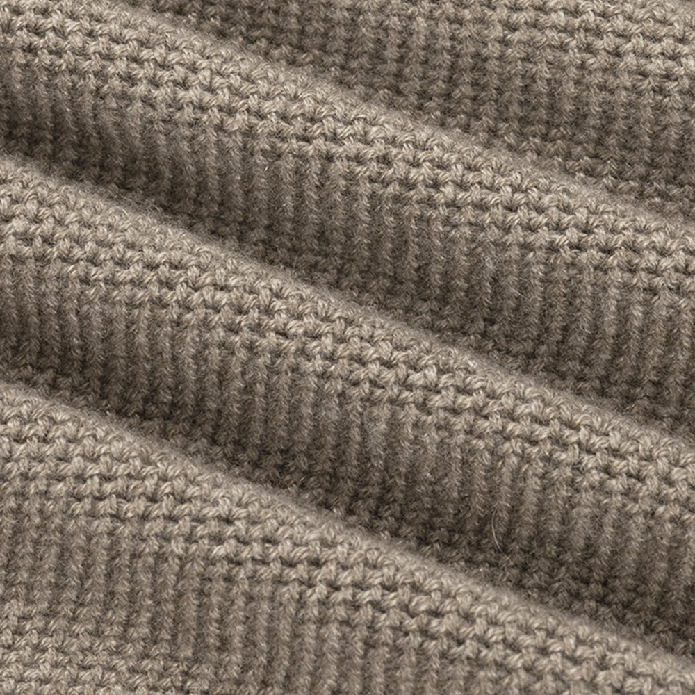 Close-up of a textured beige fabric with a ribbed pattern