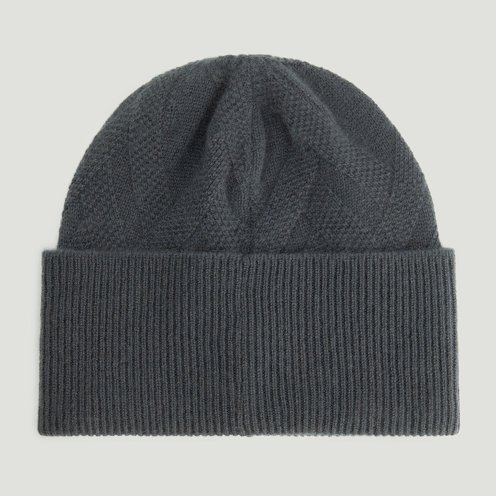 Dark gray knit beanie on a light gray background