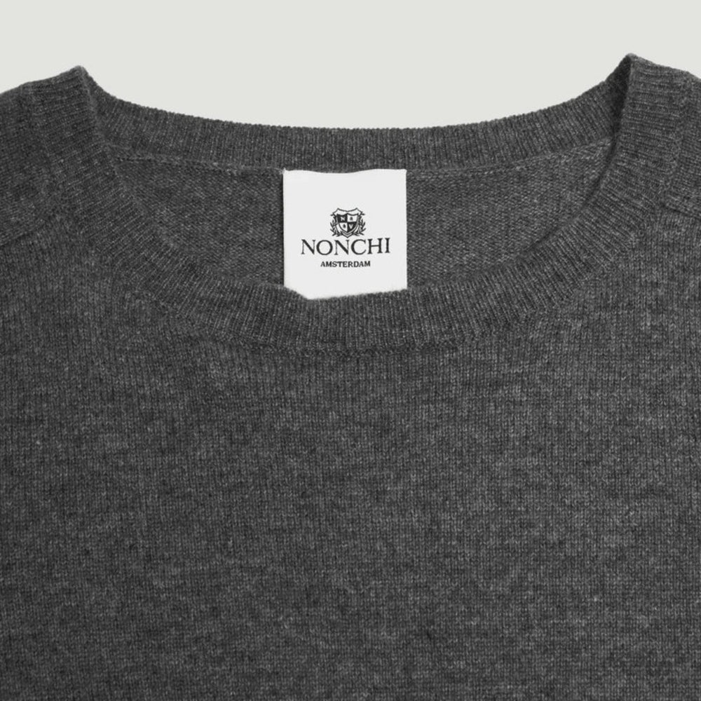 Gray sweater with a Nonchi label on a light gray background