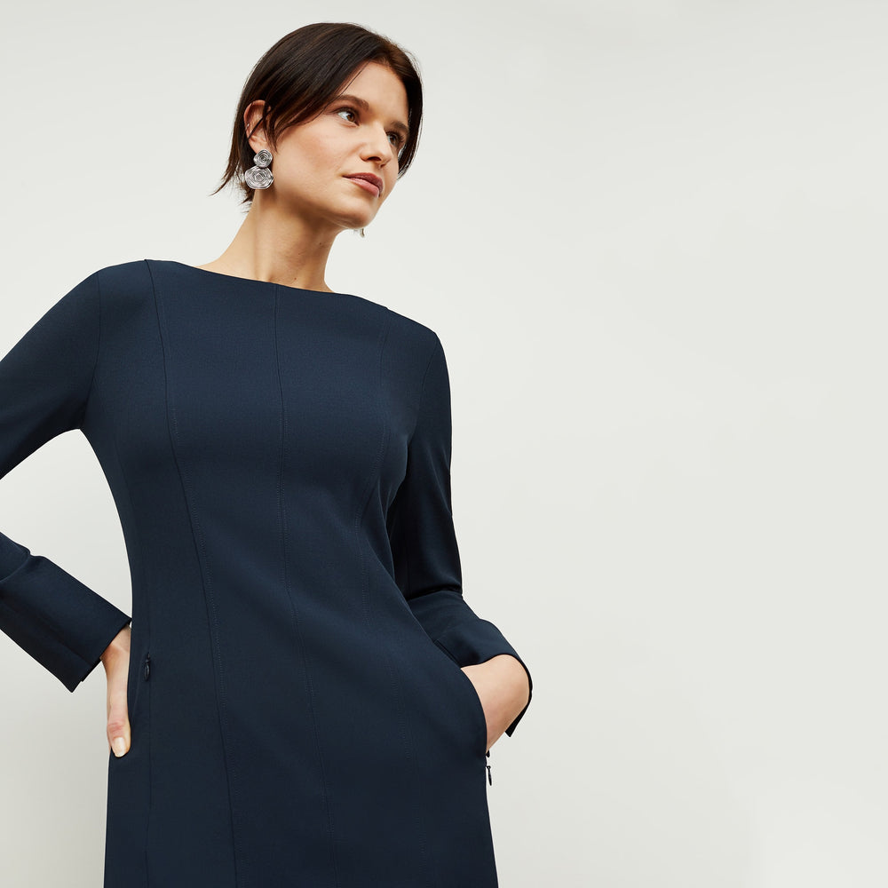 Detail image of a woman standing wearing the Novara Dress—Recycled WonderTex in Midnight