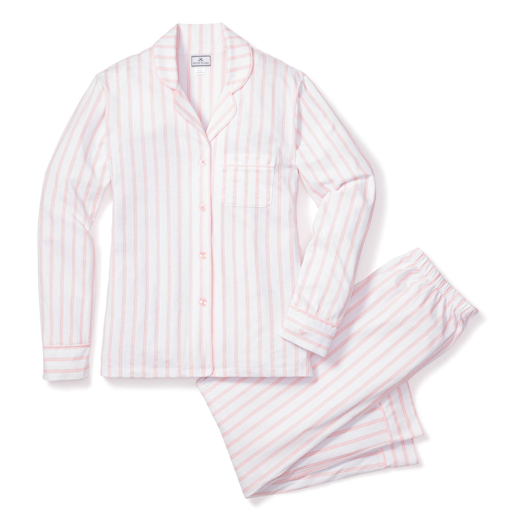 Pink and white striped pajama set on a white background