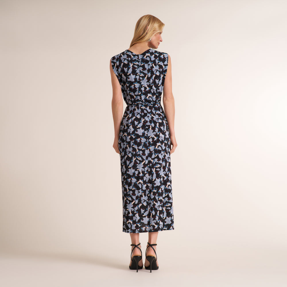Woman wearing a patterned navy and light blue printed sleeveless midi dress