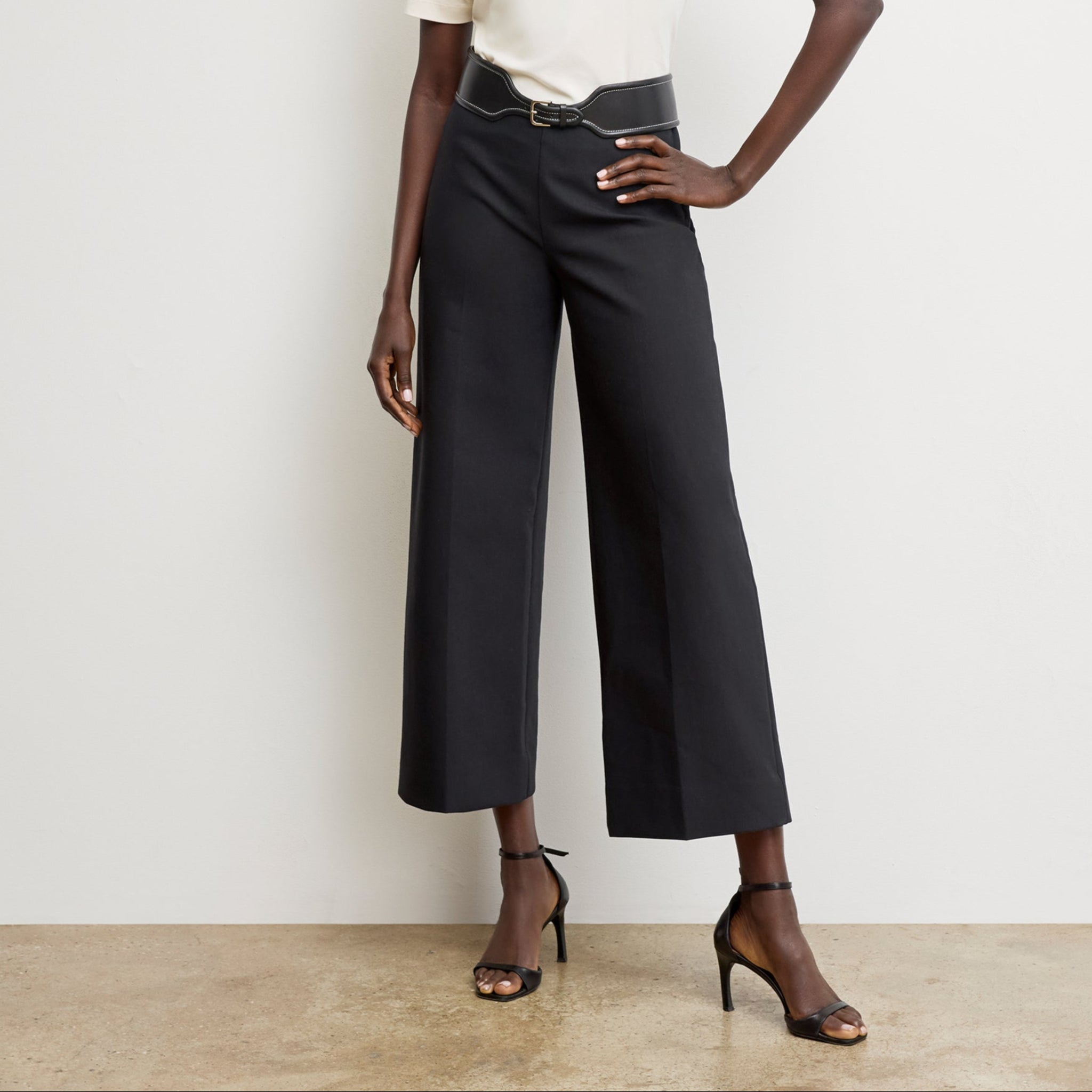Front image of a woman wearing the adler pant in black 