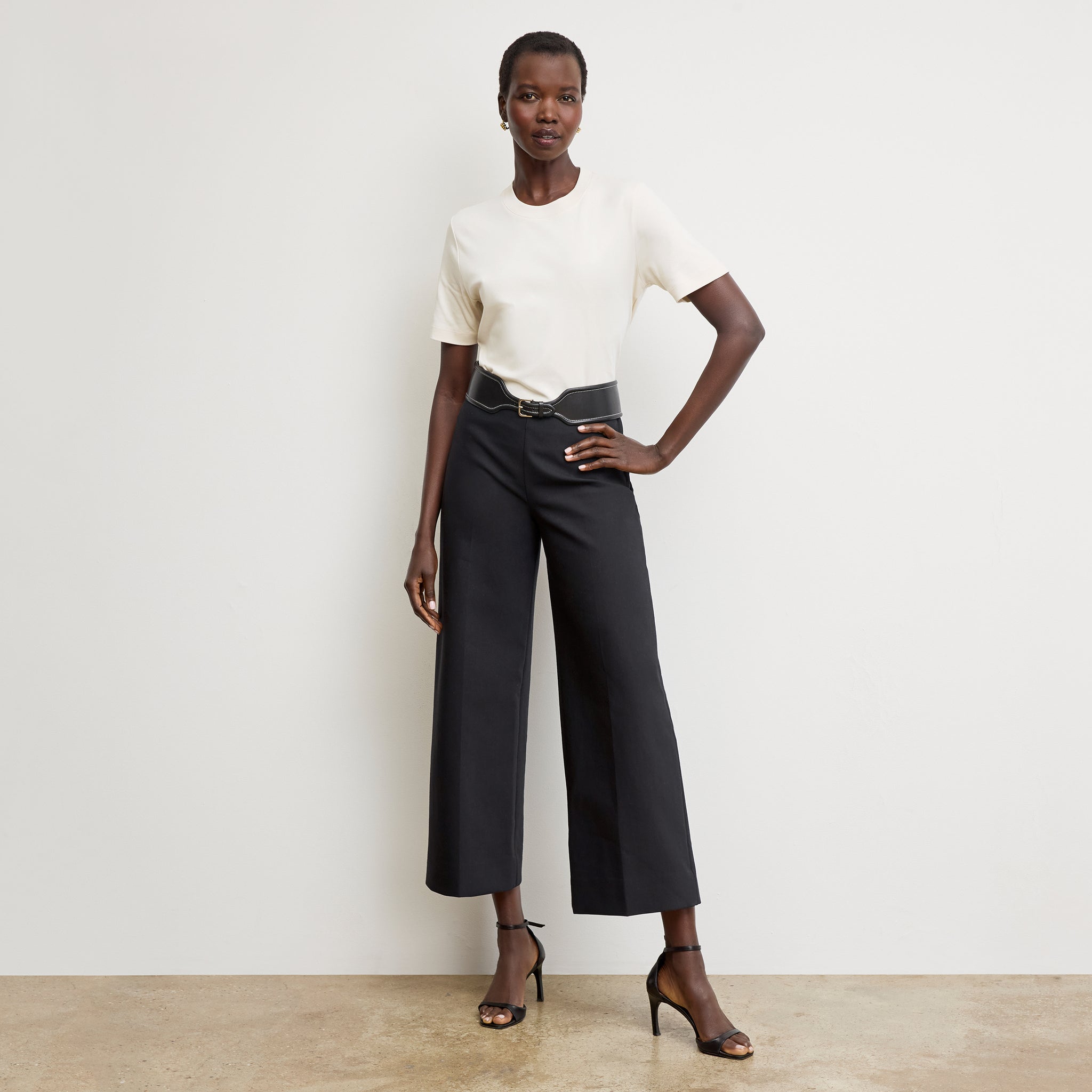 Front image of a woman wearing the adler pant in black