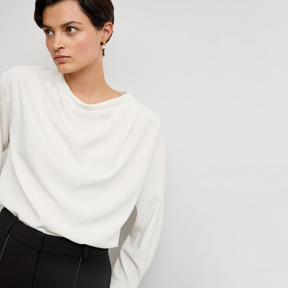 front image of a woman wearing the annmarie top in ivory