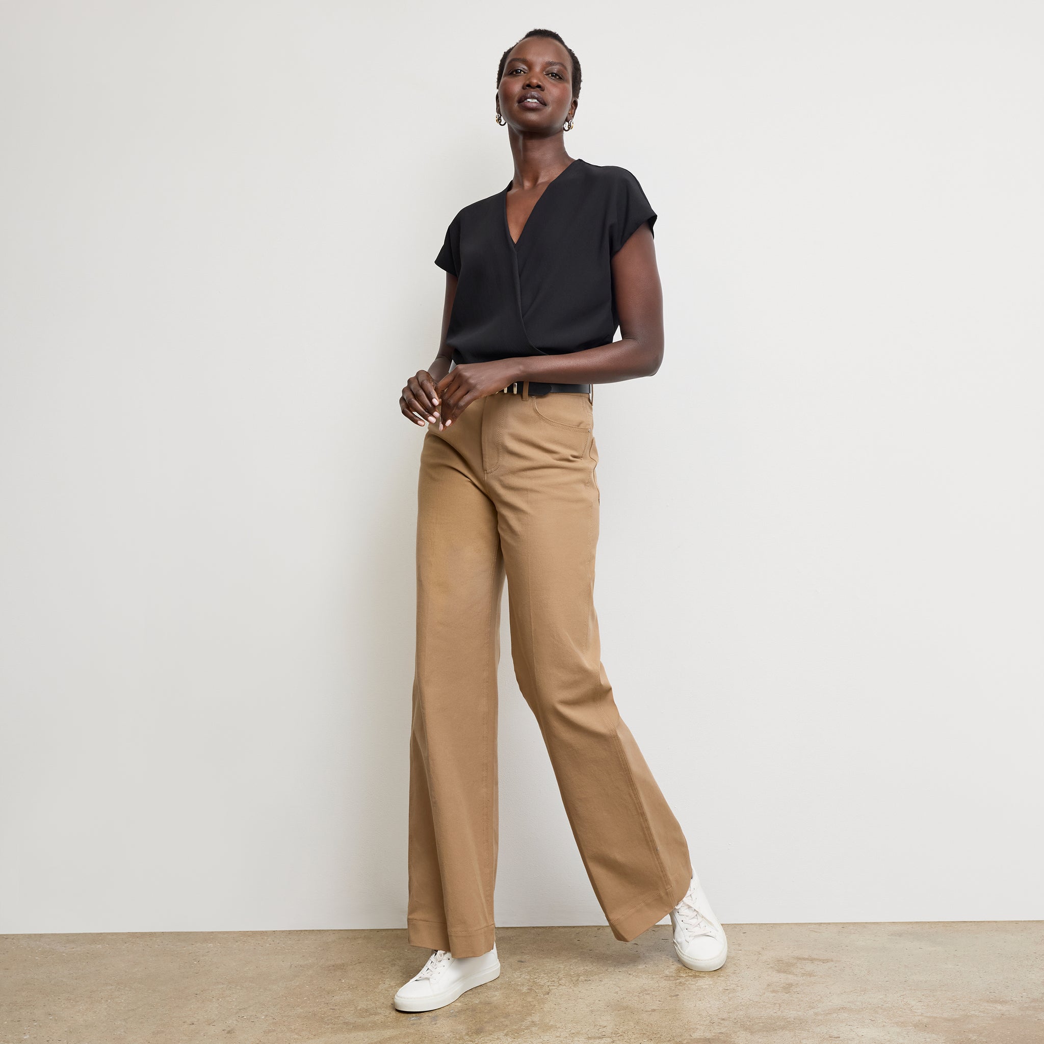 Front image of a woman standing wearing the antonia top soft wave in black