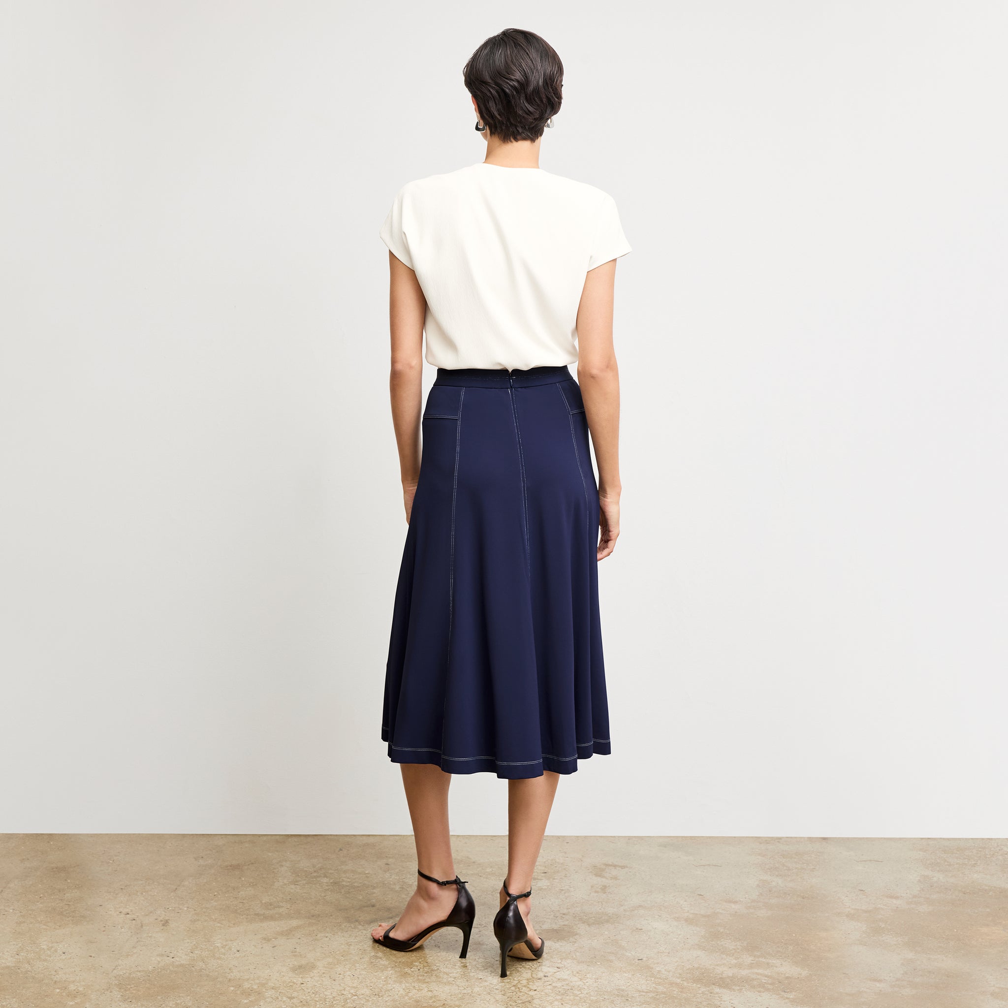 Front image of a woman standing wearing the Antonia Top—Soft Wave in Alabaster