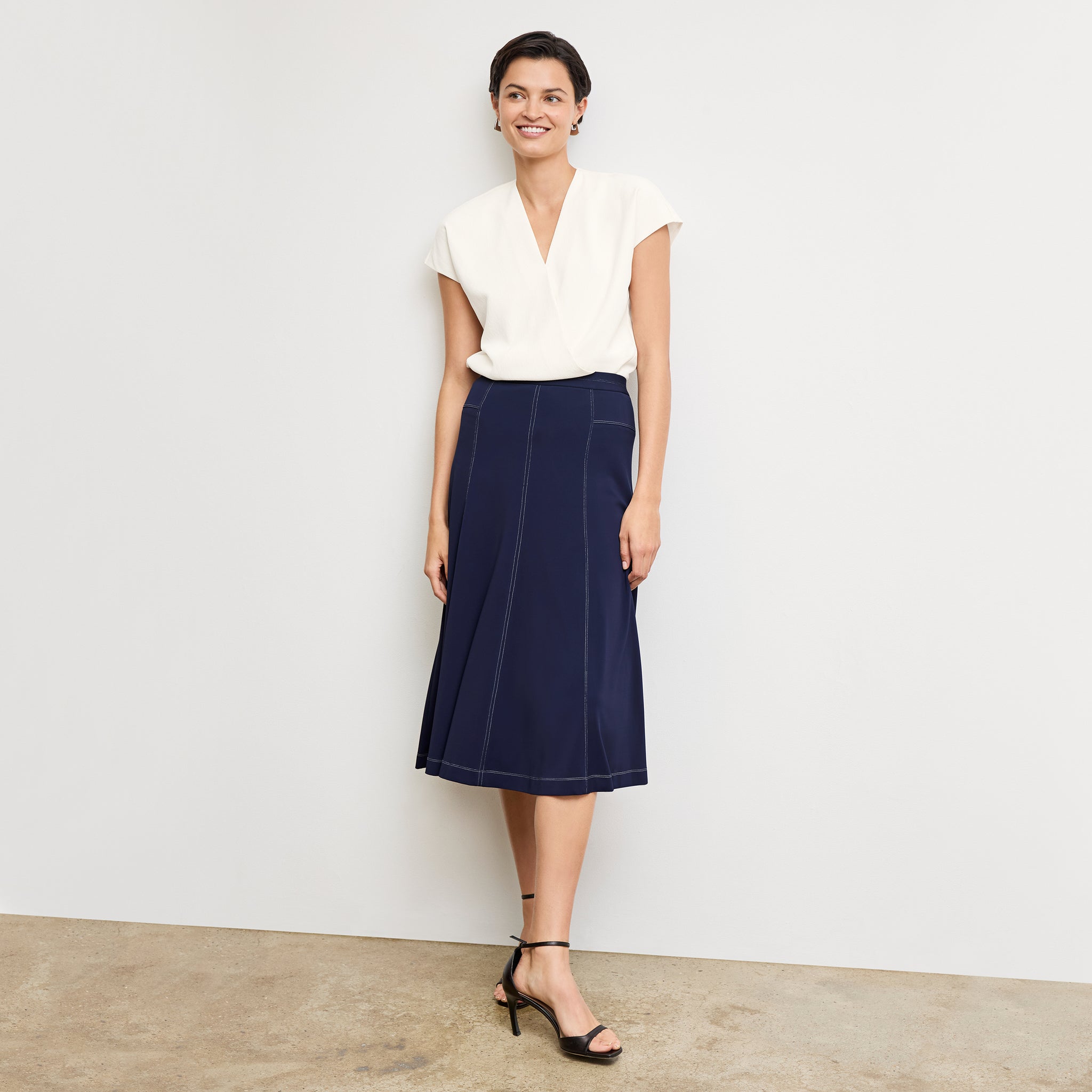 Front image of a woman standing wearing the Antonia Top—Soft Wave in Alabaster