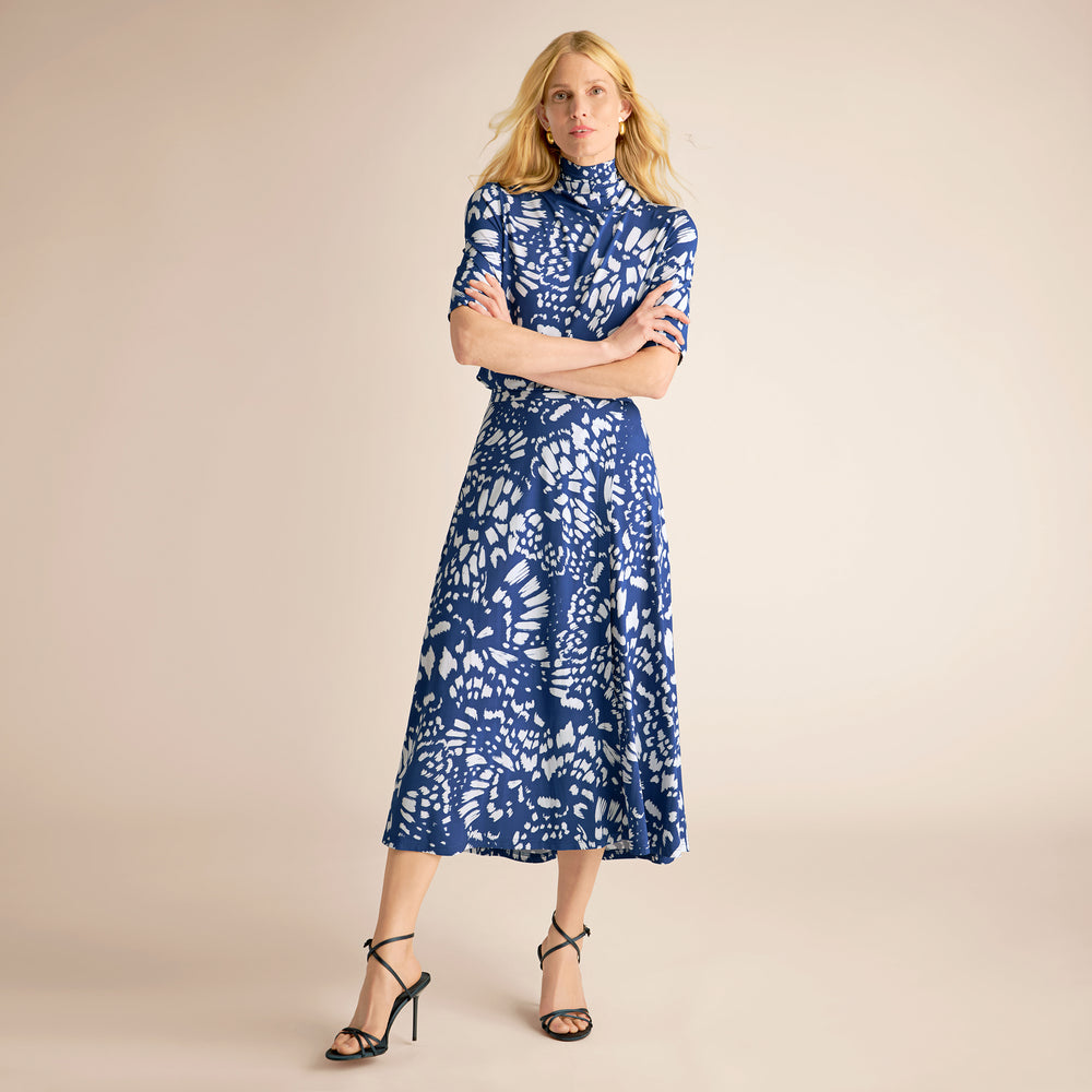 Woman wearing a blue floral dress on a beige background