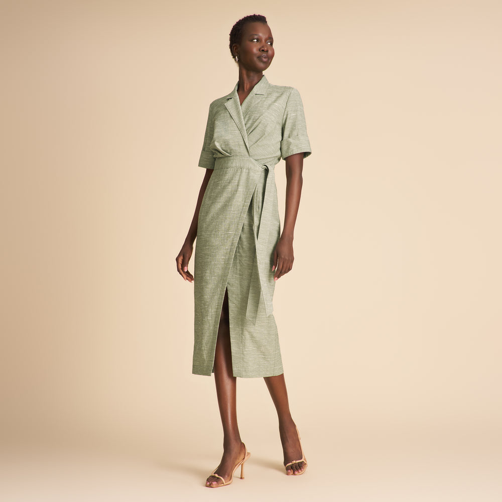 Woman wearing a green dress on a beige background