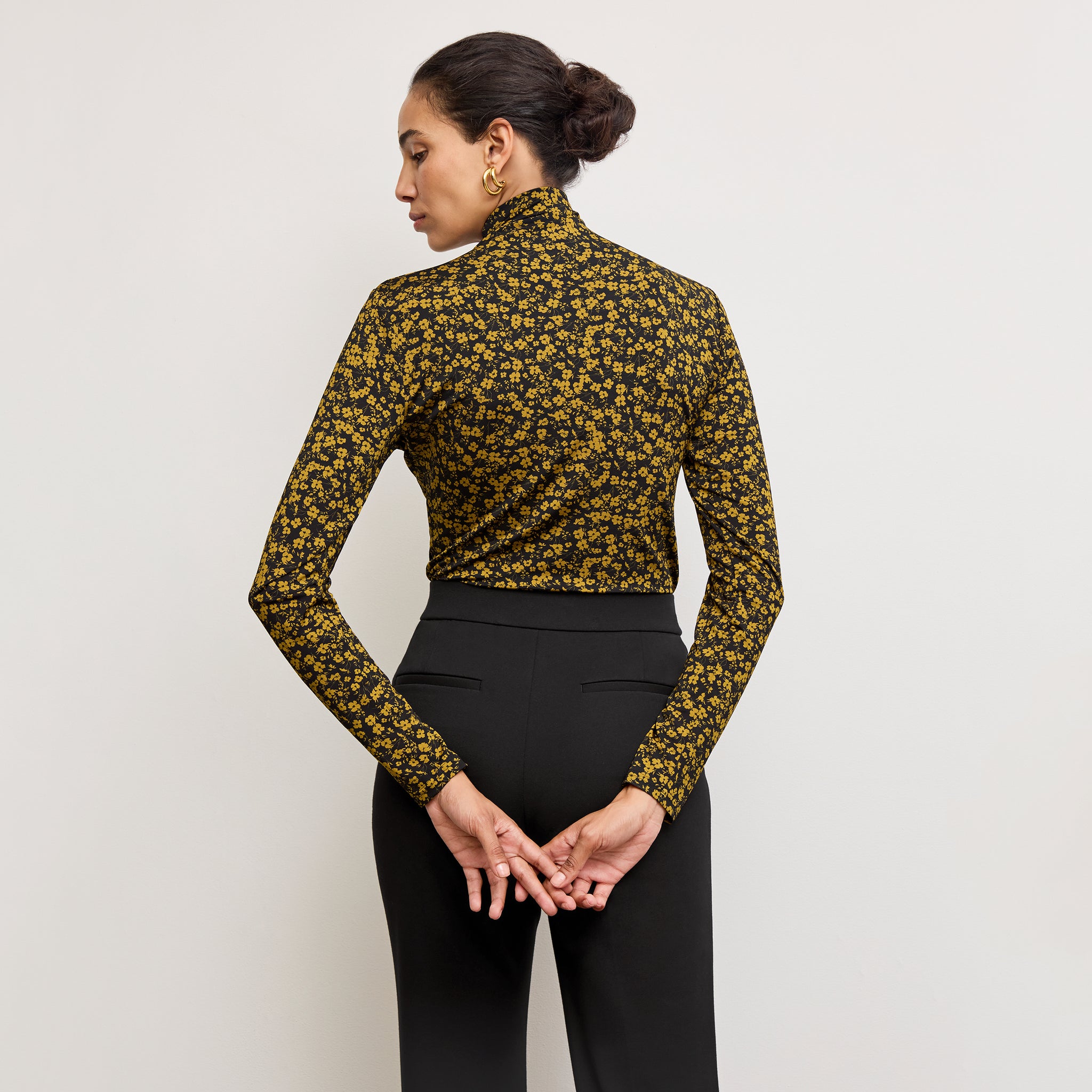 back image of a woman wearing the axam top in bloom print 