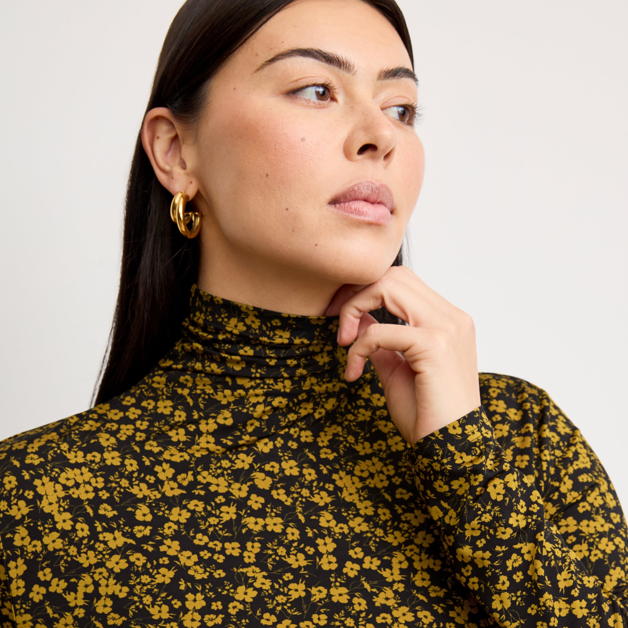 front image of a woman wearing the axam top in bloom print 
