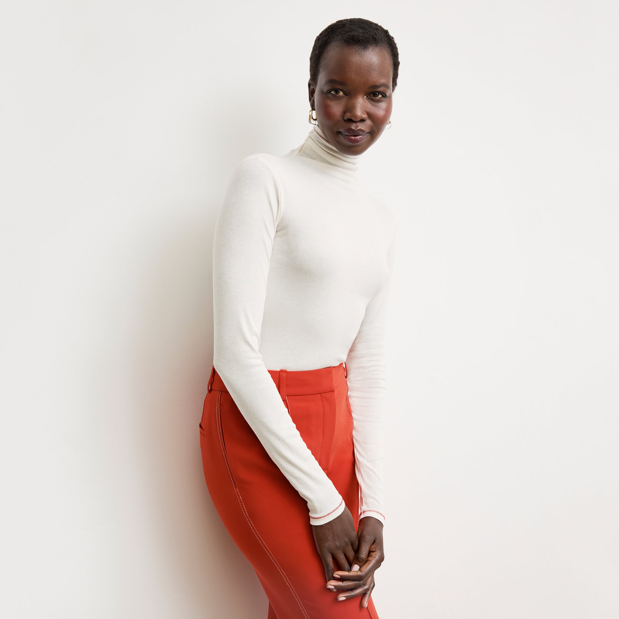 front image of a woman wearing the axam top in white 