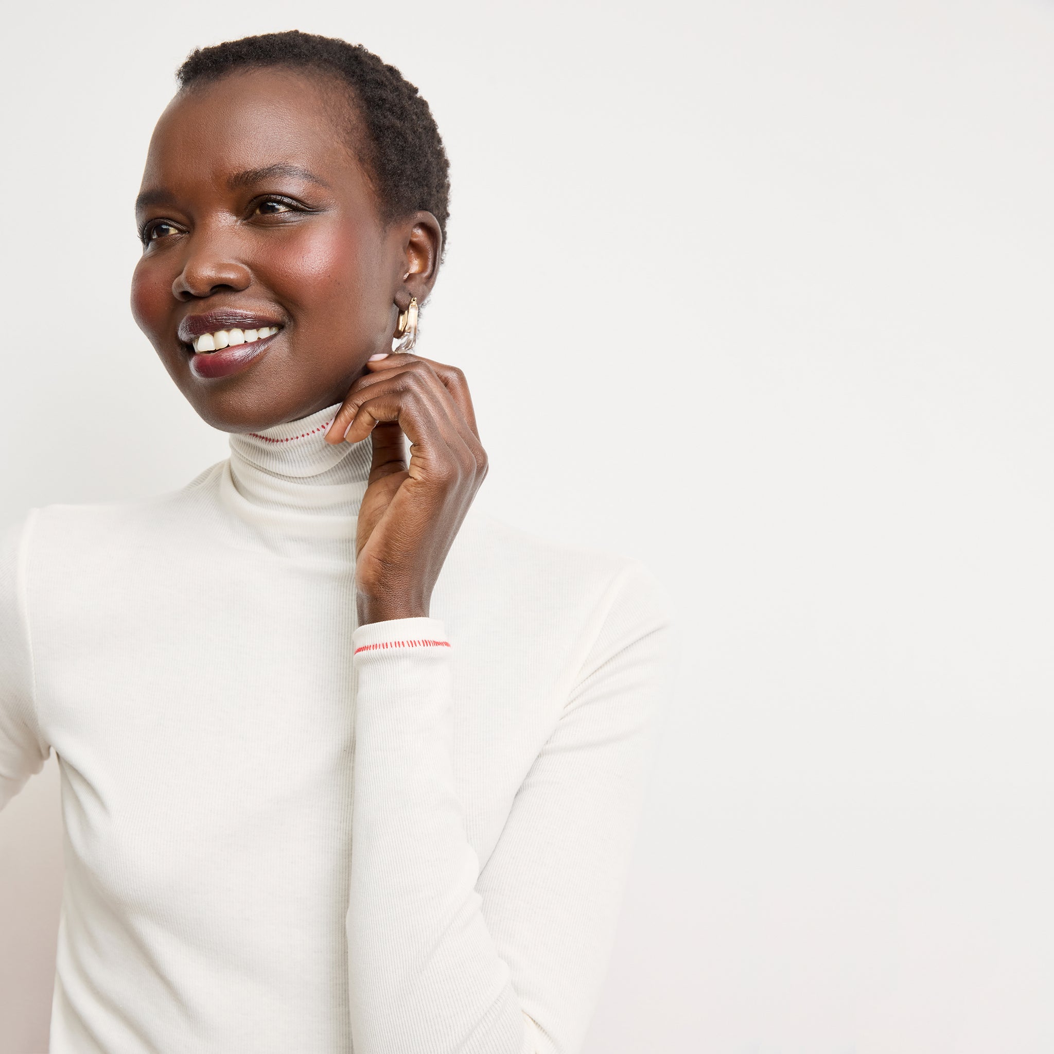 front image of a woman wearing the axam top in white