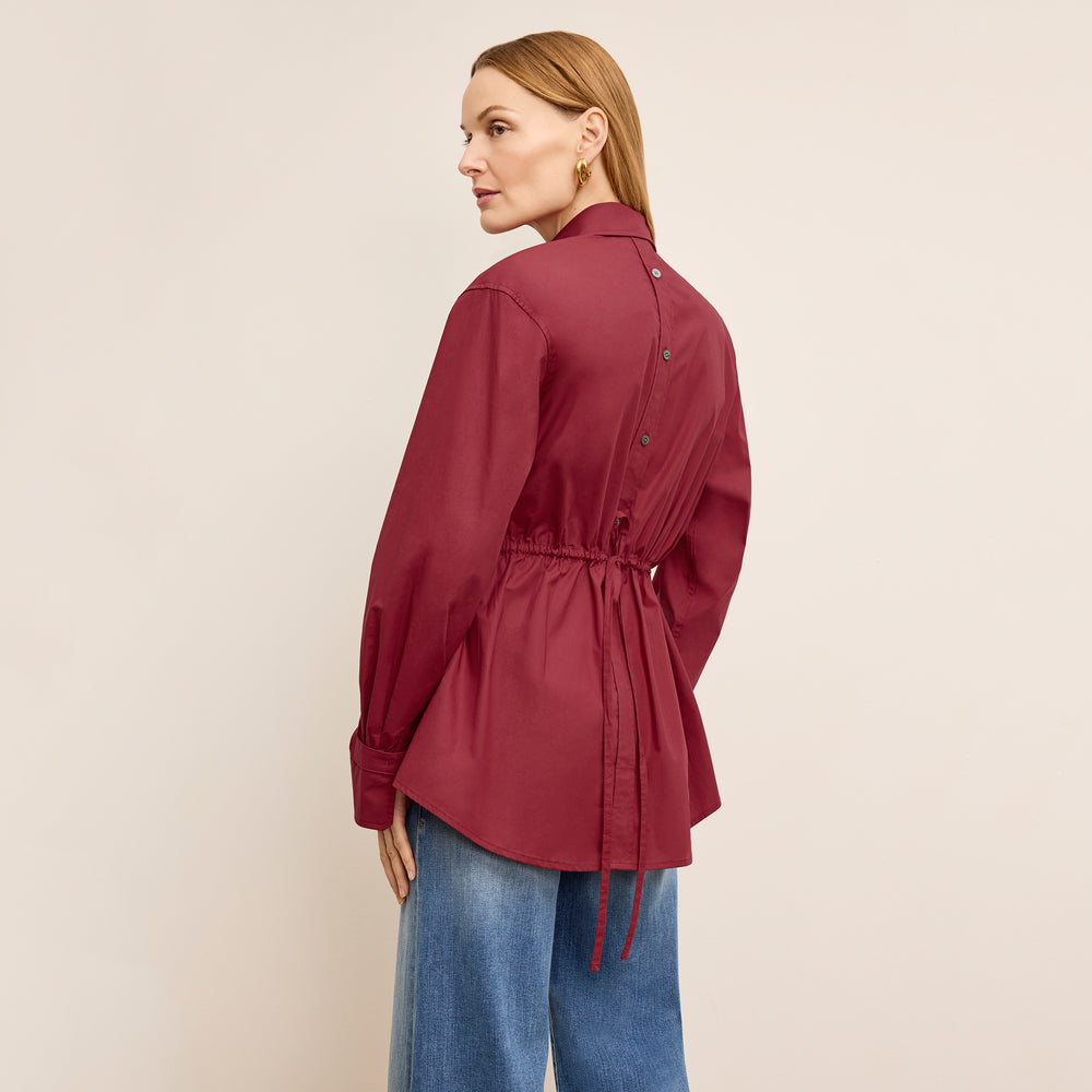 back image of a woman wearing the bentley shirt in cinnabar