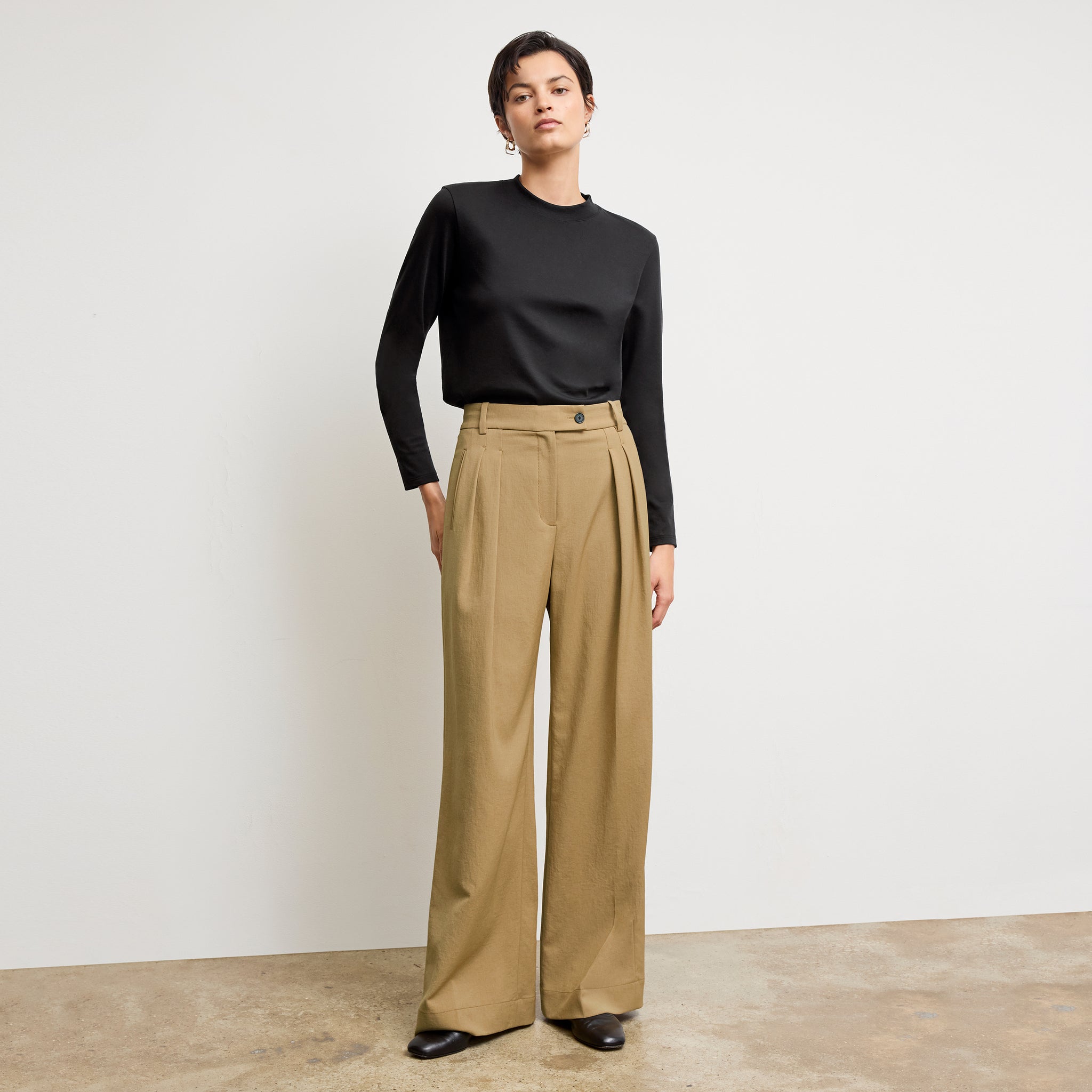Front image of a woman standing wearing the Raquel T-Shirt in Black