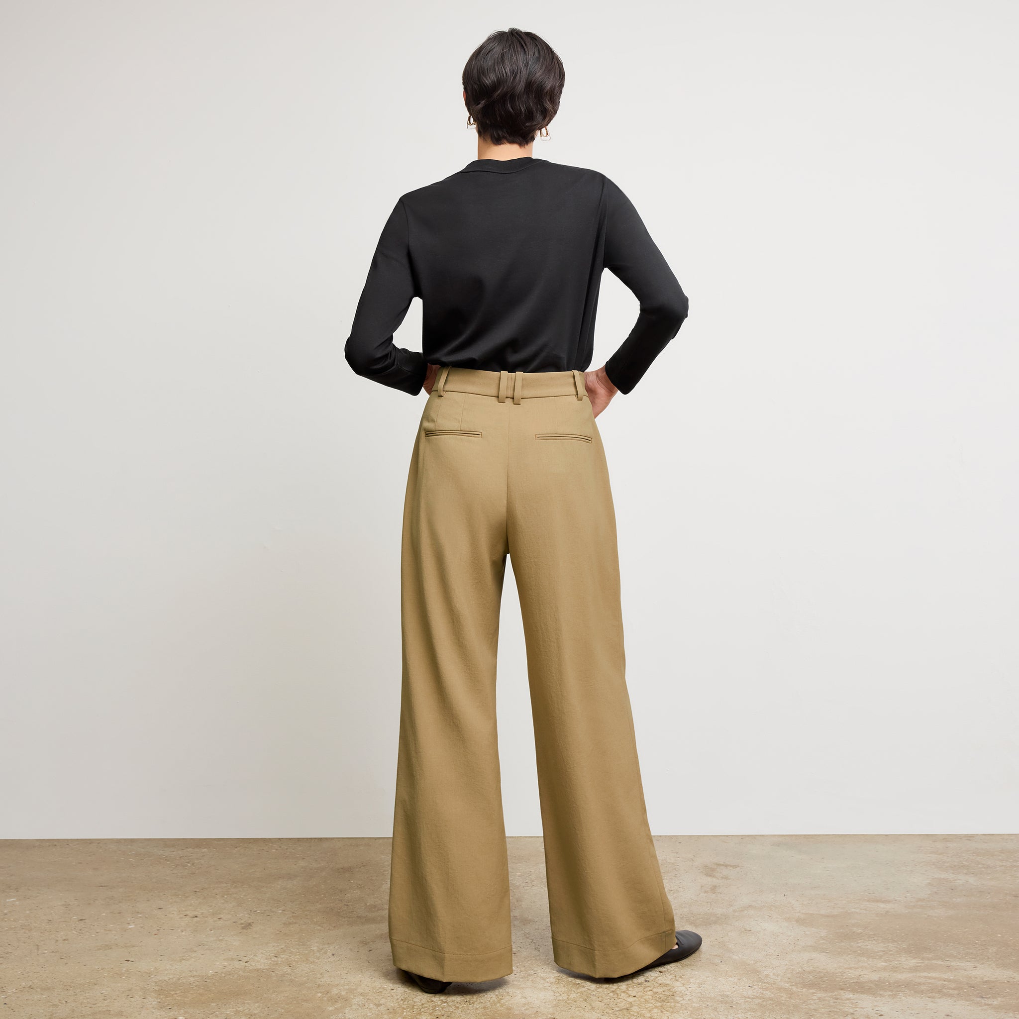 Back image of a woman standing wearing the Raquel T-Shirt in Black