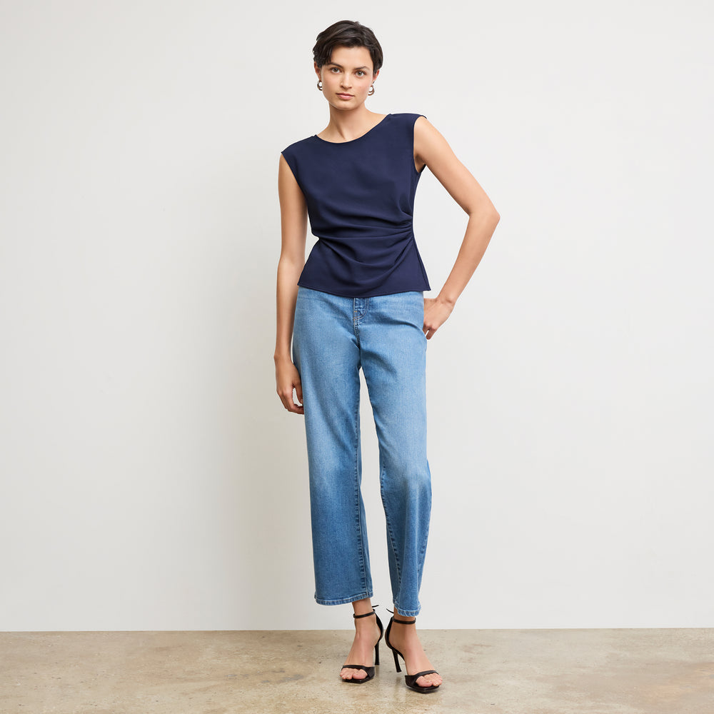 front image of a woman wearing the brooke top in soft navy