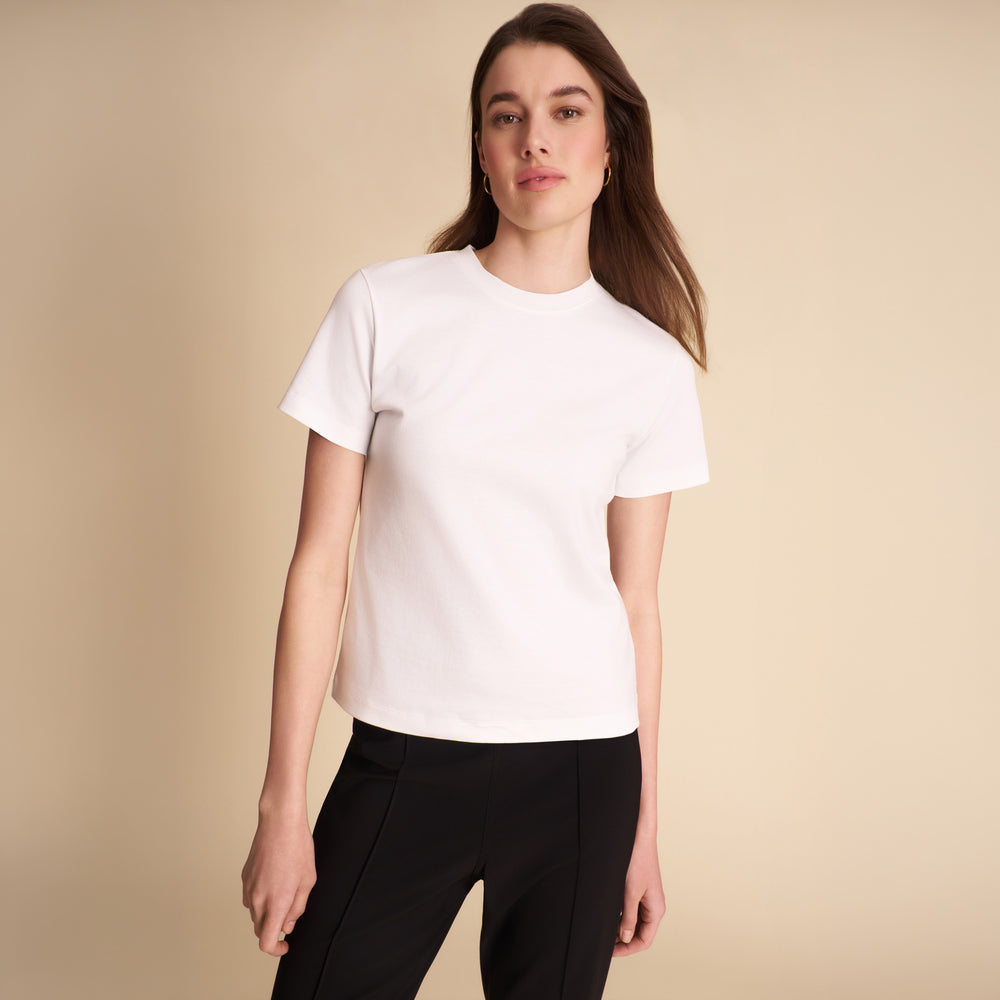 Women wearing the Leslie shirt in white on a beige background