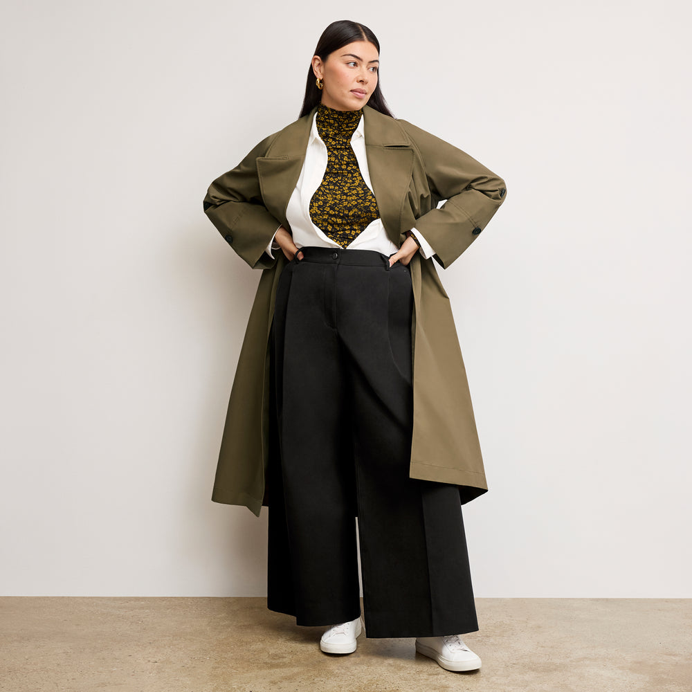 front image of a woman wearing the curtis trench in bancha green